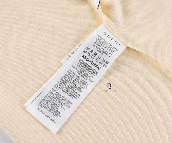 Áo Polo Gucci Interlocking màu kem logo dập tay áo